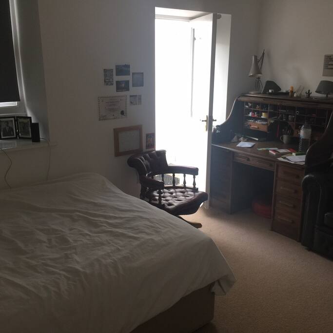 Big desk (perfect for postcard writing!) in main bedroom. Door leads out to the garden.