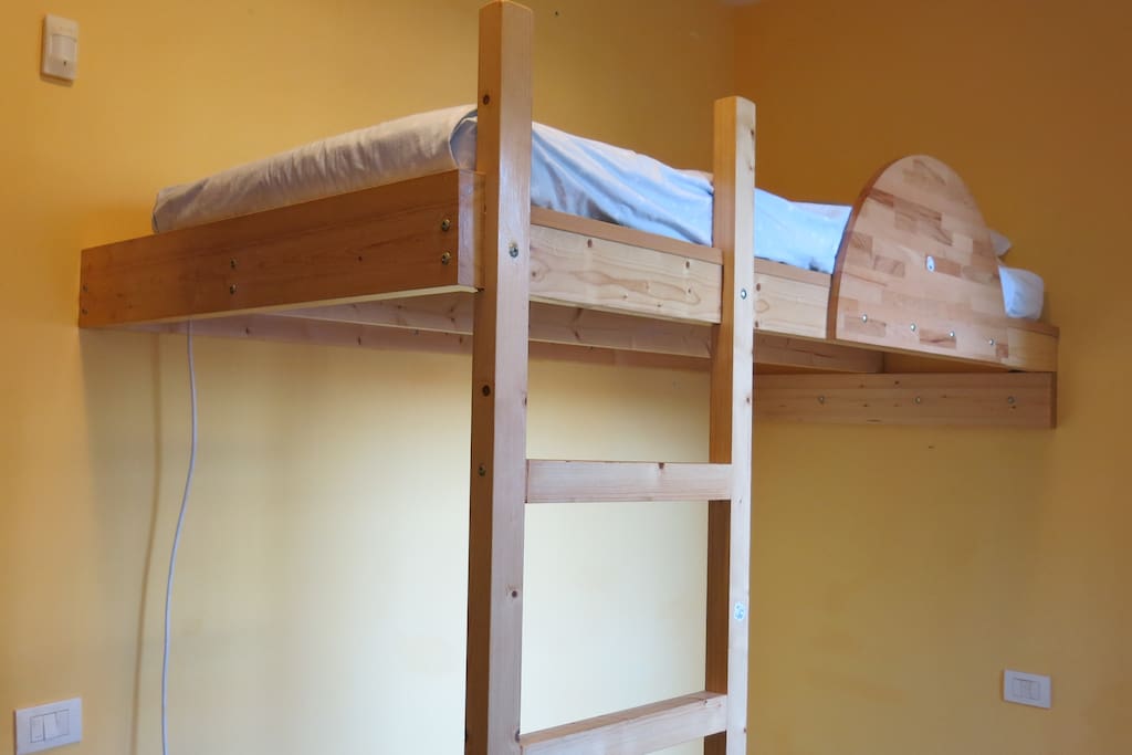 Mezzanine single bed with workspace below.