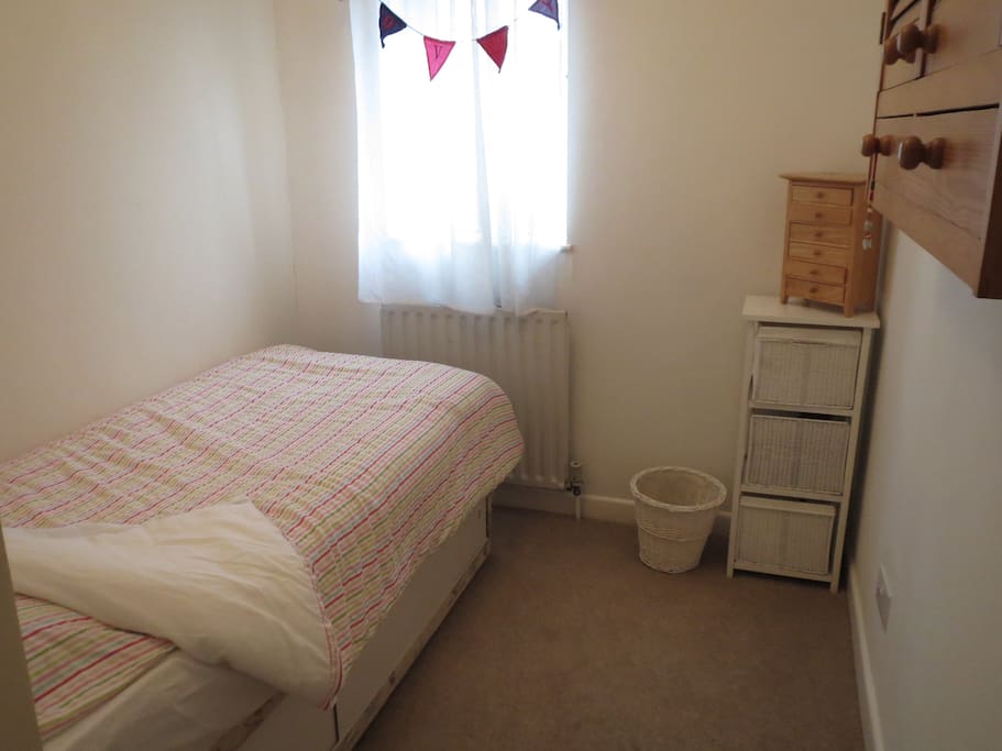Smaller bedroom, has a single bed (small bed)