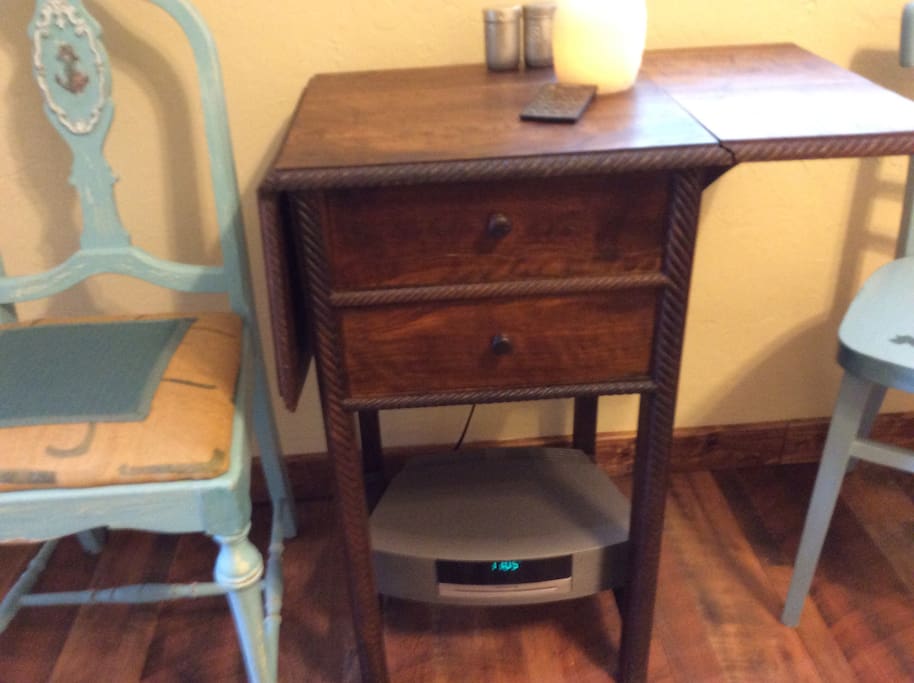 Folding antique table and Bose radio with CD.