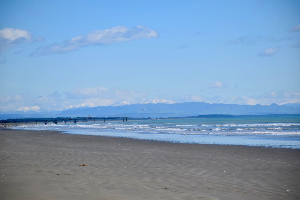 Beautiful Kaikoura Mountain range overseeing the architecturally unique Brighton Pier, iconic in Christchurch the Pier is 4kms beach walk from our gate beach entrance.