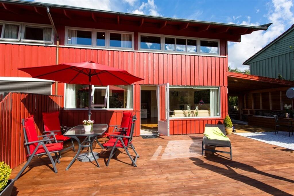 Big terrace with grill, eating area under the roof and by a lake.