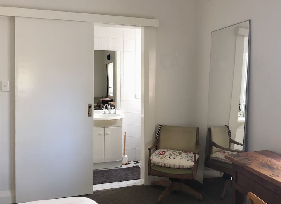 An en-suite bathroom has a shower cubicle, basin and a water closet.