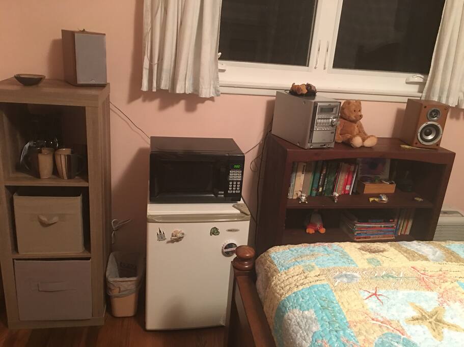 Small refrigerator, microwave, coffee maker, utensils, mugs, bowls, music, etc.