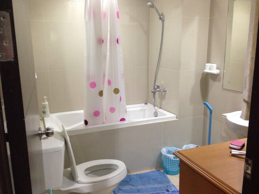 Next to the main bedroom is a bathroom with bathtub, shower, and water heater. Curtain is also available to keep the bathroom dry