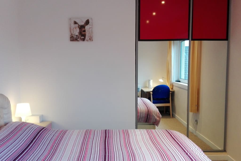 Double bed and a built-in wardrobe with a full-lenght fitting mirrors