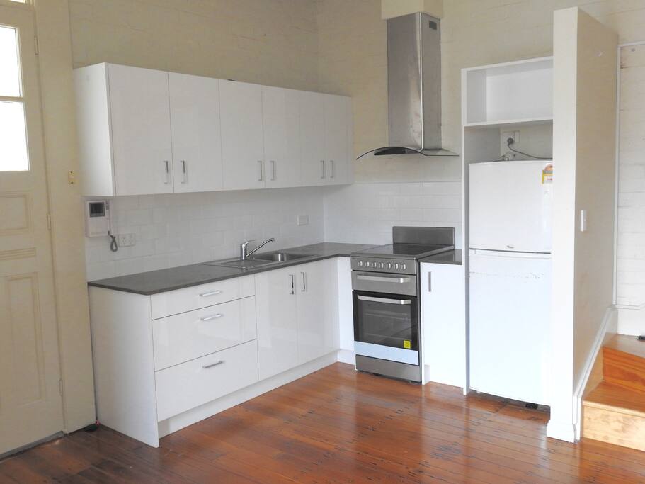 Fully functional kitchen with stone bench tops