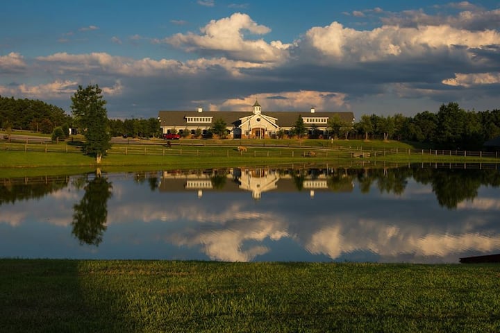 This beautiful stable facility sits on 400 acres of land including walking trails, and a fishing pond !