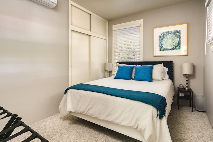 ห้องนอนด้านหน้าเตียงควีนไซส์ที่สะดวกสบายมีผ้าห่มและหมอนเสริมให้บริการ