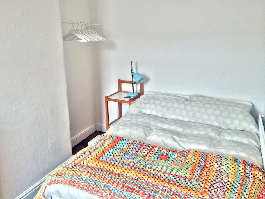 Guest bedroom - comfy bed, handy clothes rail, and side table and lamp with conveniently located power supply for your phone