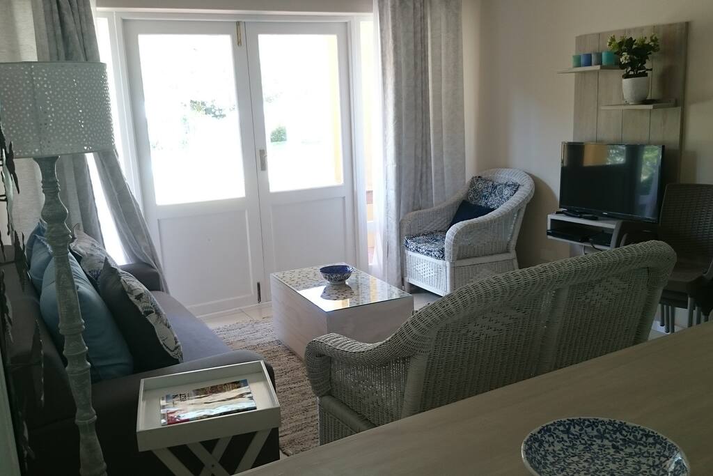 The lounge is open plan with the kitchen offering plenty of comfortable seating and doors opening on to the patio
