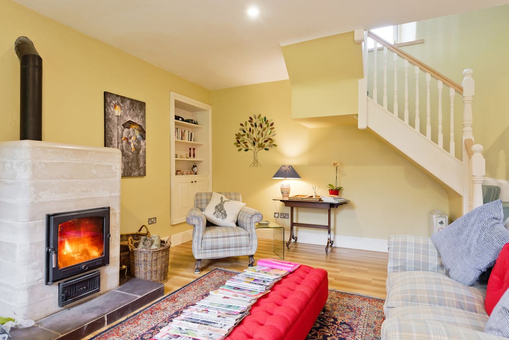 Spacious, light and airy living room with French window opening out to the Orchard. Ceramic wood burning stove.Dining table that can seat 8 with access to a small fitted kitchen.