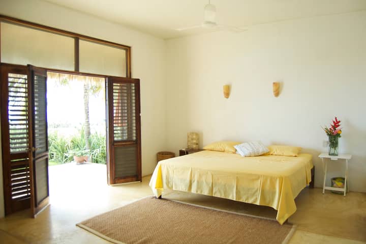 Master Bedroom with king size bed, en suite bath,  with view to the beach and pool