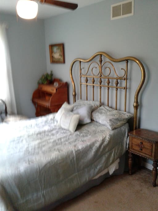 View of antique brass bed, desk, chair and night stand.
Ceiling fan, central heat and
a/c.