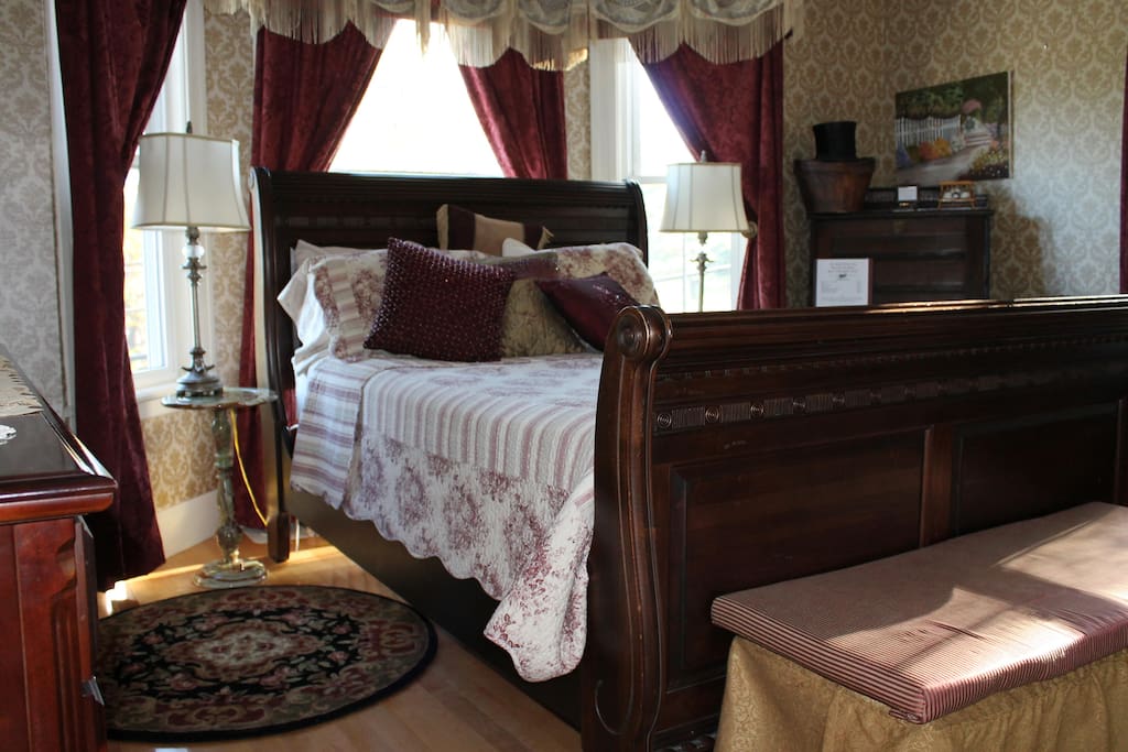 This room is rich in color and decor. Features a Queen Sleigh bed, custom drapes, antique furniture yet has all the amenities you require.