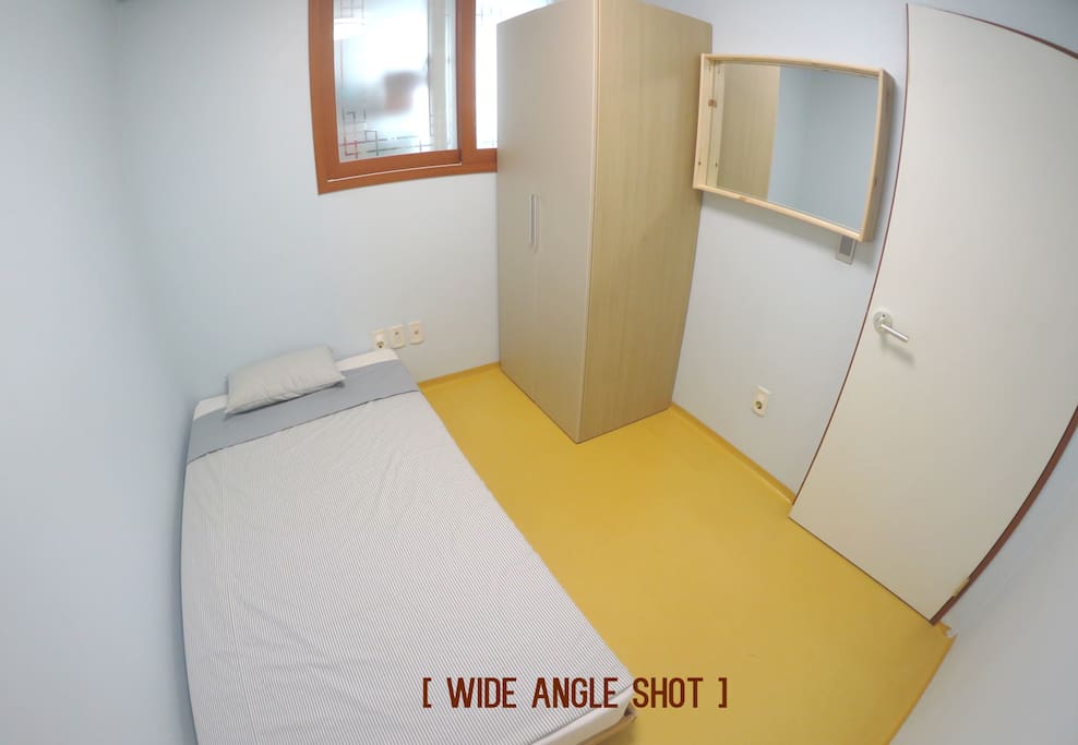 This is a wide-angle shot of the room. You have a comfortable bed, a wardrobe and a mirror. We'll provide you with more bedsheets and fresh towels. The room is not big, but big enough for one person to have a relaxing stay.