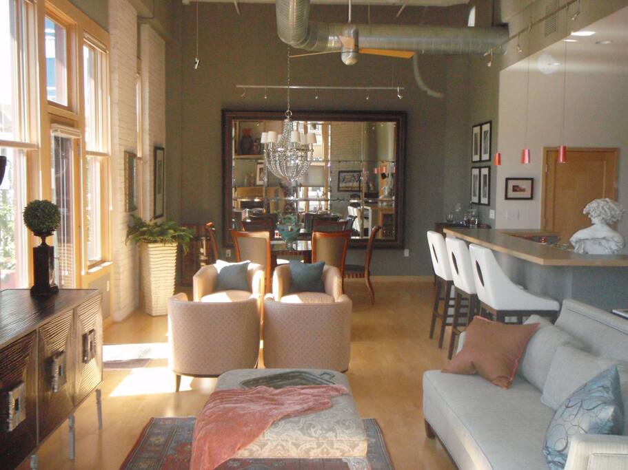 Large open concept area. The dining table at the far end has been replaced with a desk and daybed