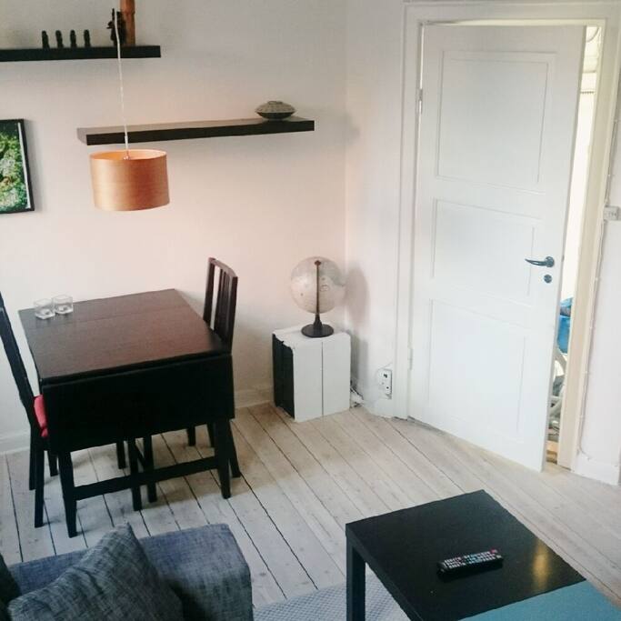 Living room with dining table, sofa and television