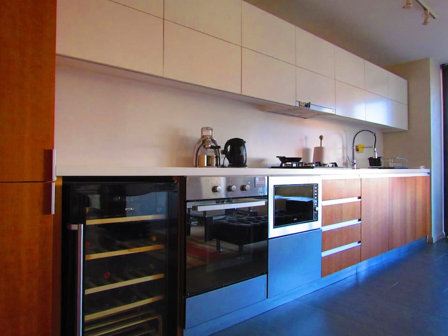 Kitchen, electric oven, microwave, wine cellar and fridge / Gran cocina americana, horno eléctrico, microondas, cava y refrigerador en muebles