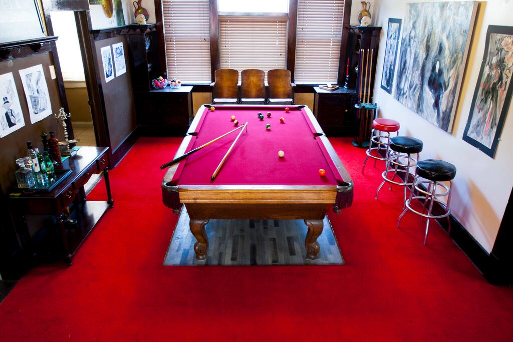 Pool room covered in fine art and entertainment amenities.