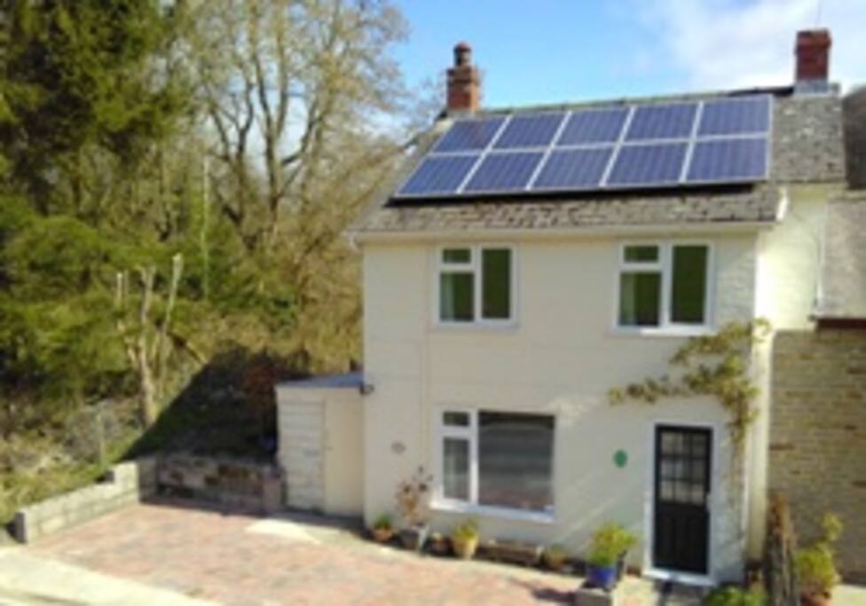 Front of cottage with parking area
