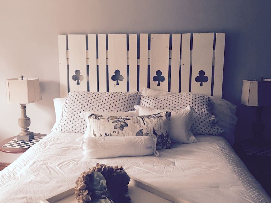 3rd-floor queen bed with headboard we built with vintage shutters found at an antique store. Soft blanket in room and down comforter available.