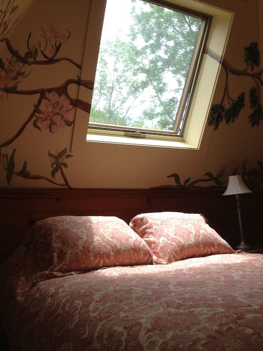 Loft bedroom- 1 queen bed. Bedroom walls are hand painted with birds and tree branches. Skylight allows for star gazing at night!