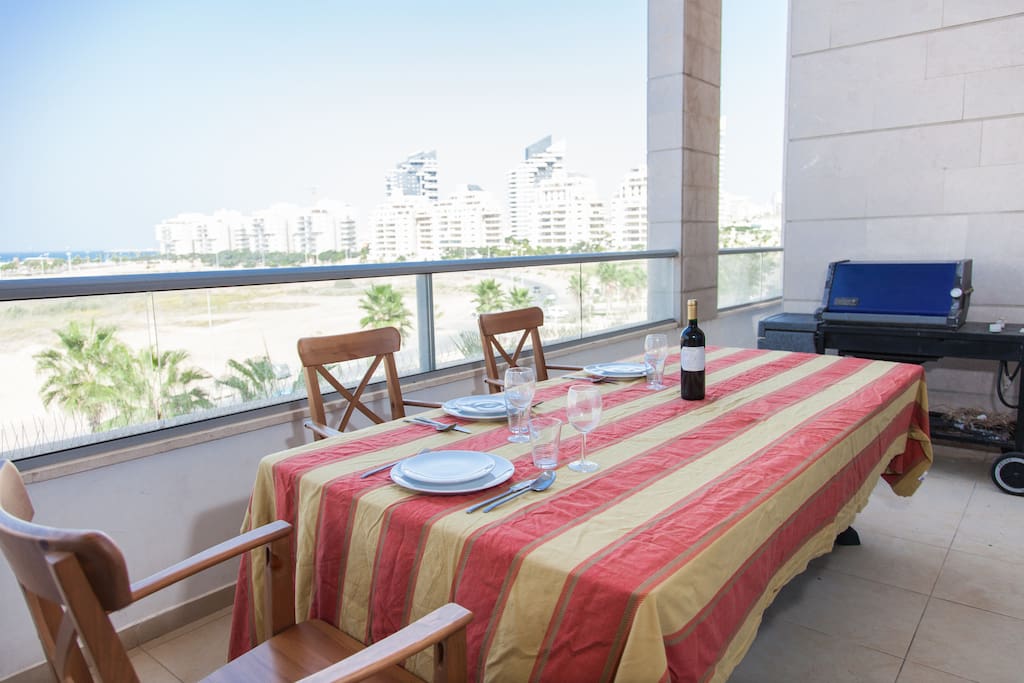 Large terrace with dining table and Weber BBQ
