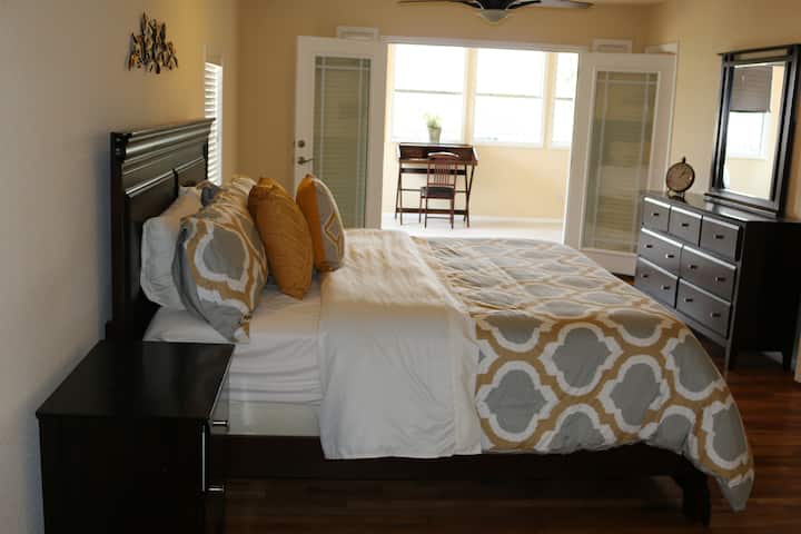 Главна спалня, отворена към офис и кът за сядане.