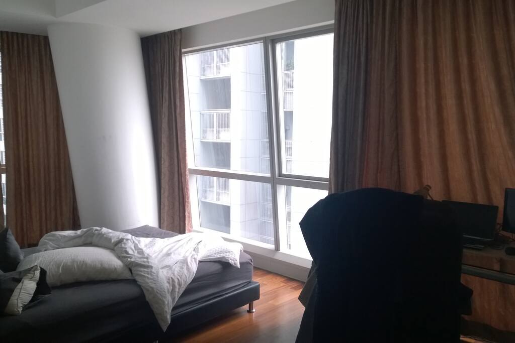 Separate bedroom with view of the marina bay view frm above 50th. Has bed, study table and chair and built in large wardrobe