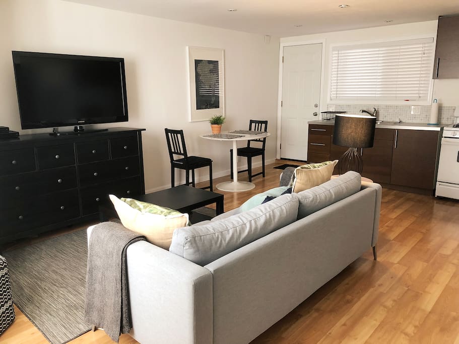 The main living space has a comfy couch that you can stretch out on, a full kitchen and an eating area. That's the 46in flat screen TV with HBO and a Blu-Ray player, if you were wondering.
