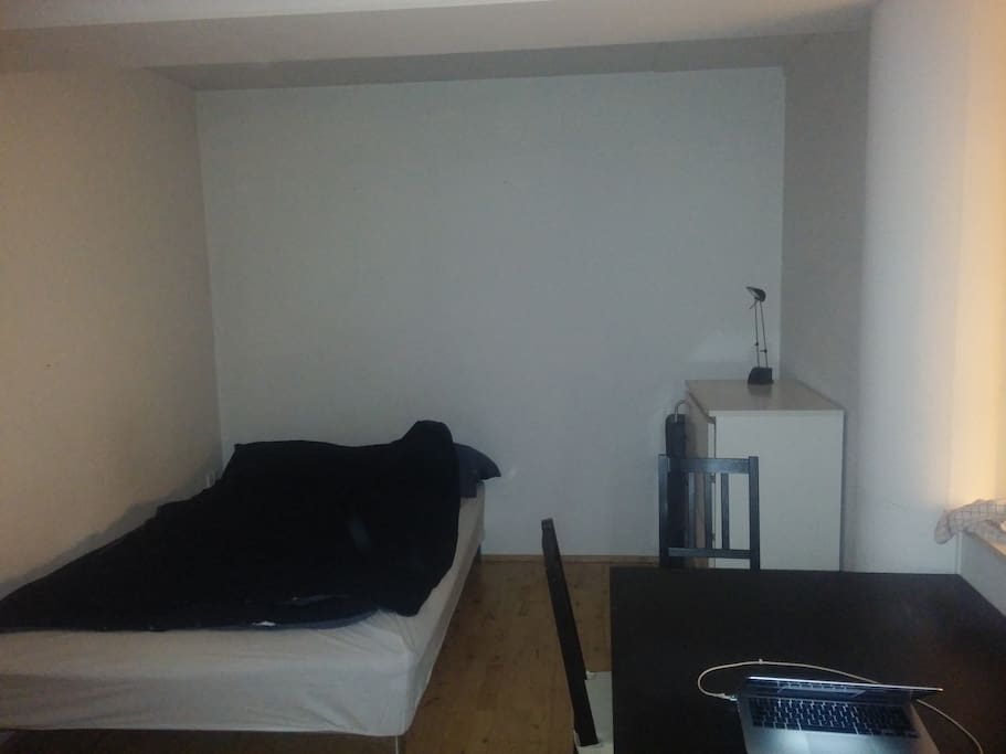 Corner opposite the door, bed and kitchen table
