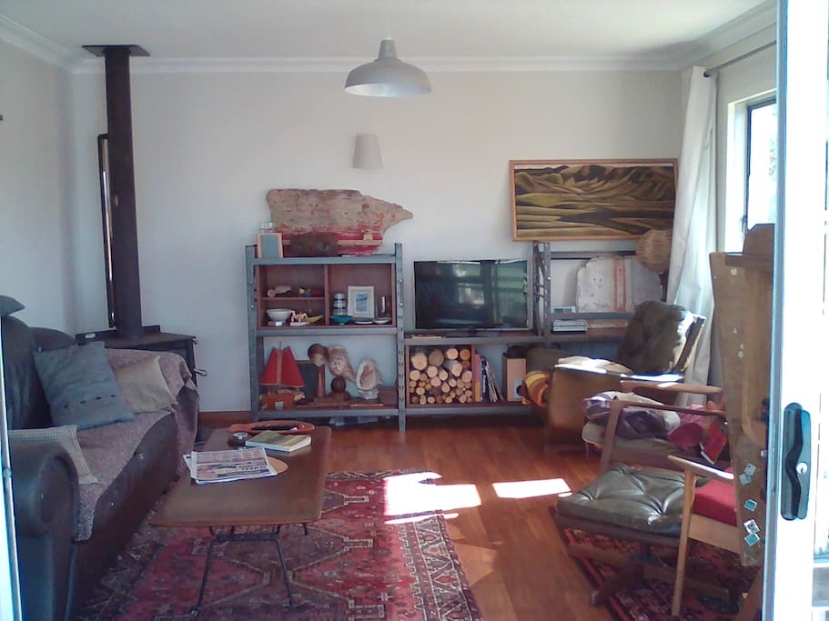 funky, light and bright living room opens to deck.