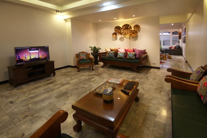 Large living room with traditional Thai furniture and Ultra HD (4k) Smart (Internet) TV.