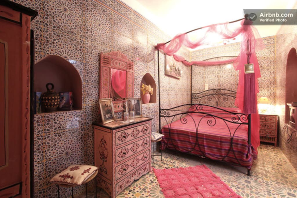 The pink room is the only bedroom at the bottom floor and it has a private bathroom.