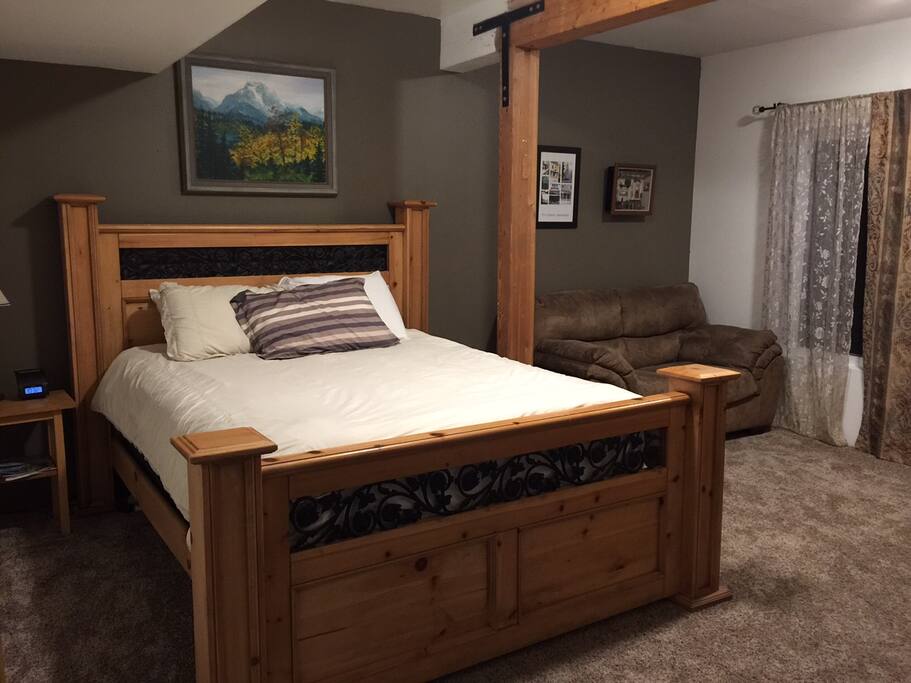 Guest room with queen pillow top matters, sofa, TV & DVD player, and armoire.