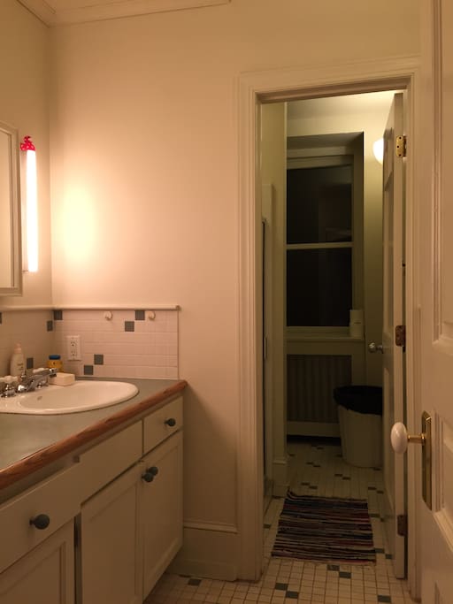 Shared bathroom with separate shower/toilet area.