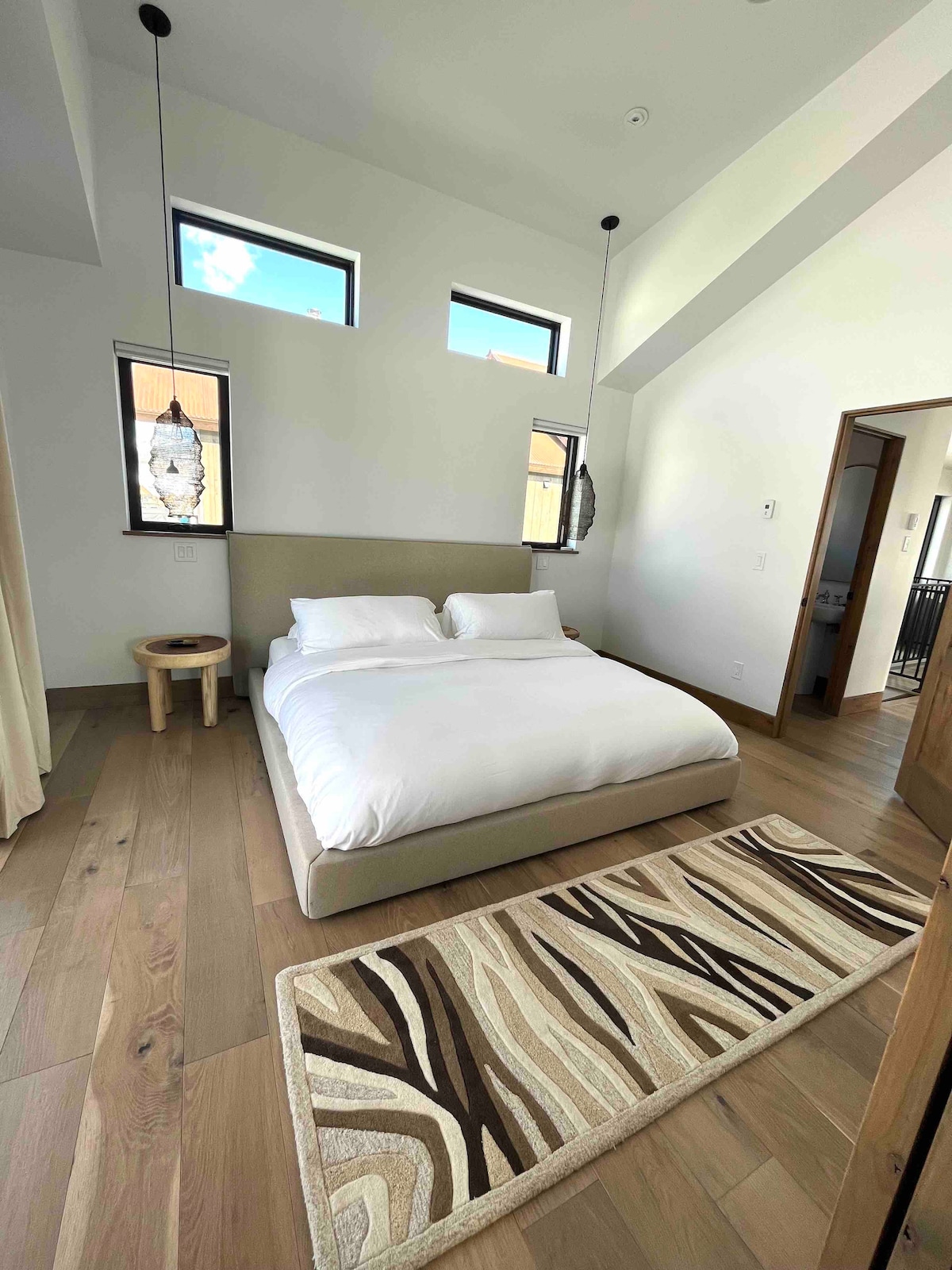 A super cozy Maiden Home platform bed is topped with a down duvet and bamboo sheets. 