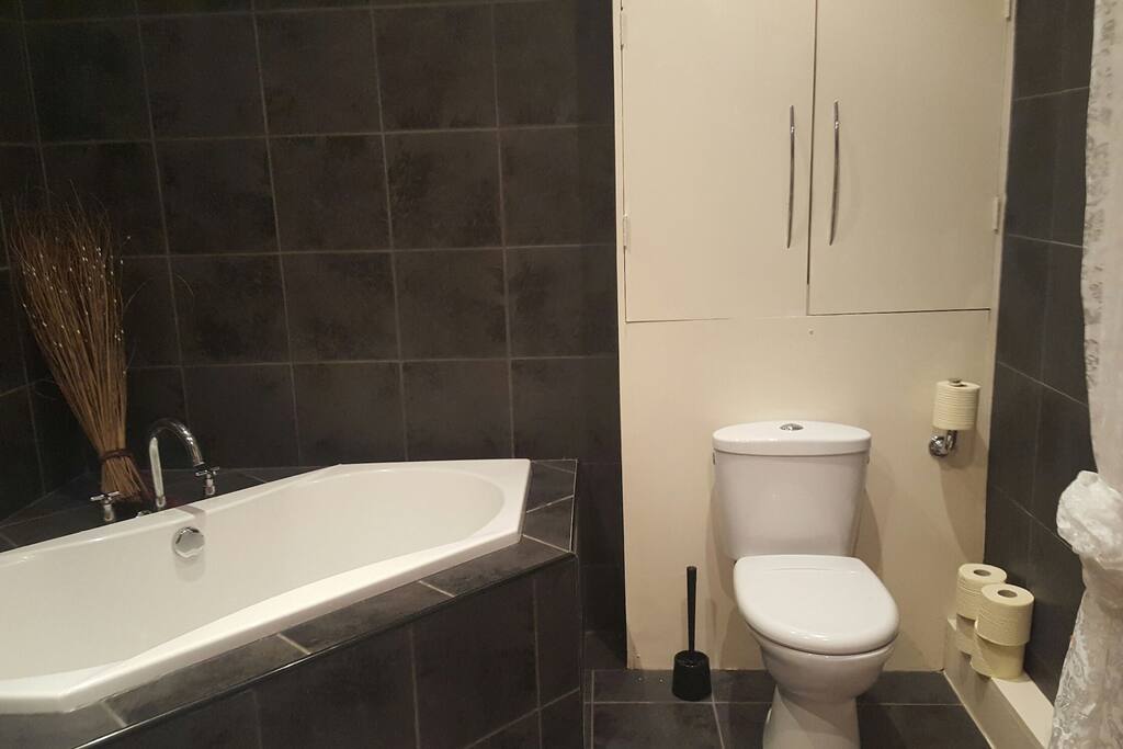 Your spacious bathroom with big bath tub and separate shower