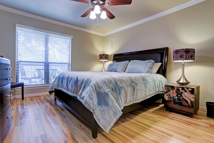 King size bed, ceiling fan in bedroom.  