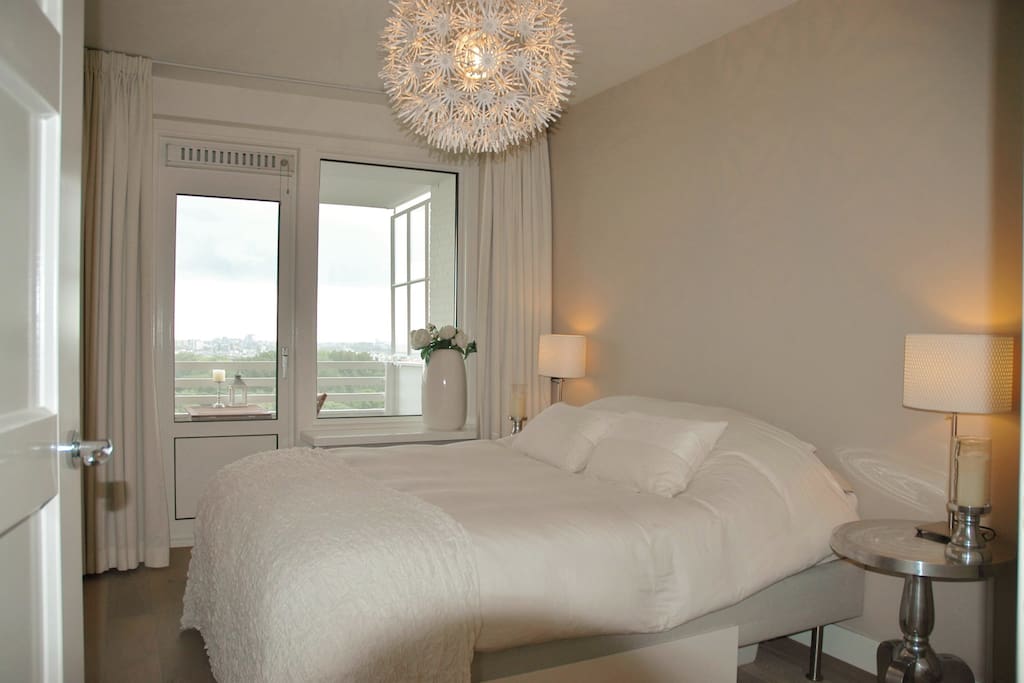 Bedroom with view and entrance to balcony