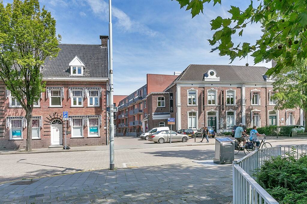 street view with in the middle the entrance to the gated square and apartment building