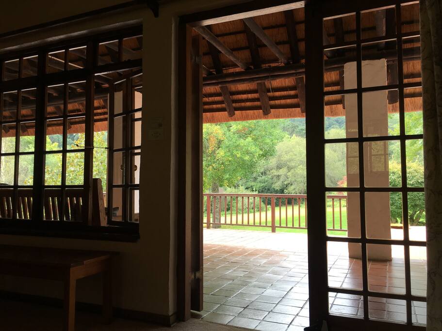 View from the bed over garden and indigenous forest