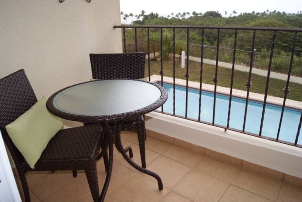Private balcony facing pool and Puerto Real Bay view.