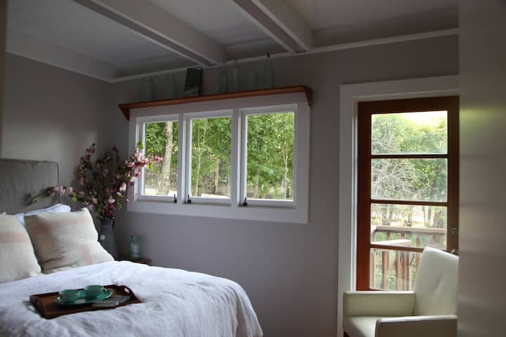 Main floor bedroom next to bathroom with full size bed and direct access to deck