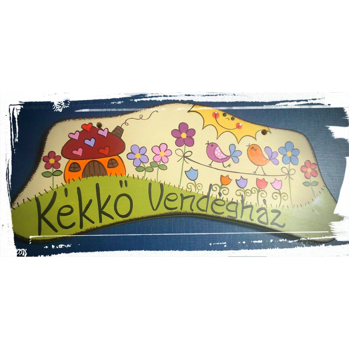 A colorful hand-painted sign features a whimsical house surrounded by vibrant flowers and cheerful birds. The name 'Kékko Vendégház' is displayed prominently, inviting guests into a friendly atmosphere. The design showcases soft curves and playful elements, contributing to a welcoming appearance.