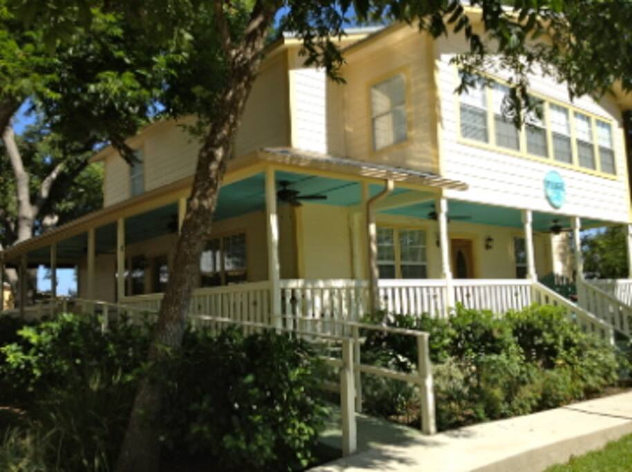 Front of home with wrap around patio.