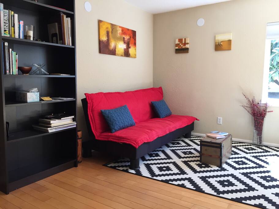 Living room futon that opens up to a comfortable full-size bed.