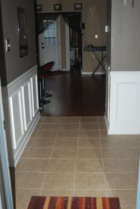 Entrance. Your bed and bath are directly to the left; which means you can come and go through the front door without ever walking through the common areas. Tile floors, closet space to the right.