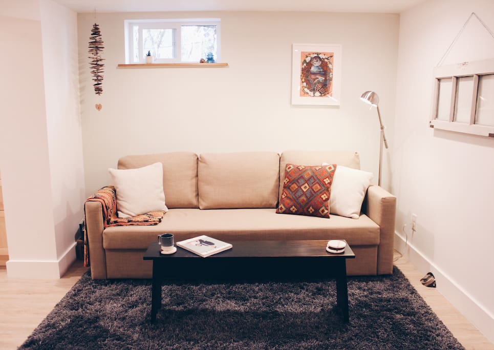 This sofa easily folds out to provide a second queen bed with plush bedding.